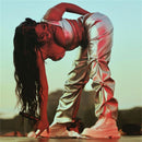 Sólido Faux PU cuero brillante mujeres pantalones Hipster High Street Irregular forma pliegues ropa cintura elástica ropa de calle femenina