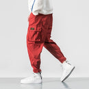 2022 Hombres Multi-bolsillo Cintura elástica Diseño Harem Pant Street Punk Hip Hop Rojo Pantalones casuales Joggers Hombre Ejército Cargo Pantalones 5XL